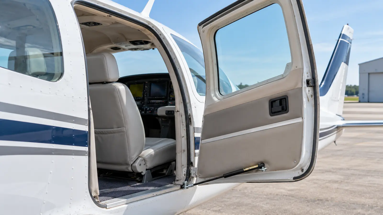 Aircraft cabin door and service hatch supported by a heavy-duty Newton aircraft cabin door gas strut